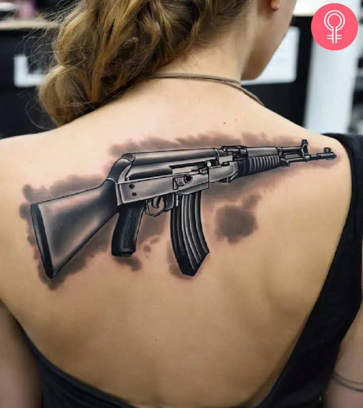 An AK-47 tattooed on the upper back
