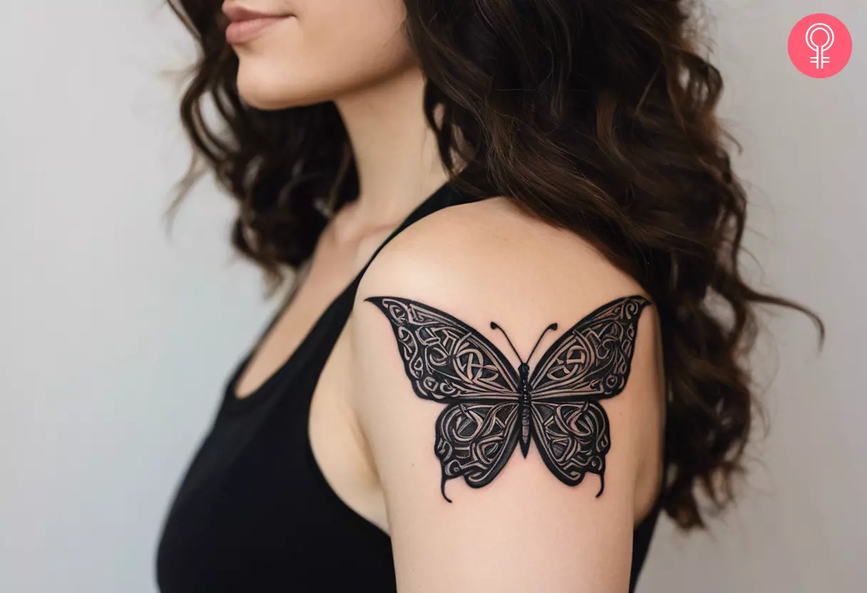 An ancient Celtic butterfly tattoo on a woman's upper arm