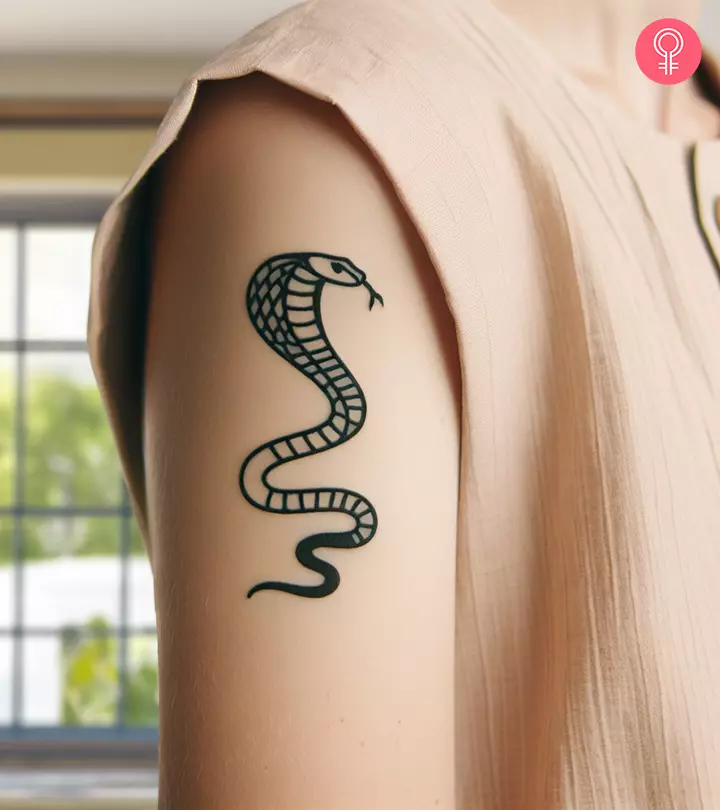 An upper arm cobra tattoo