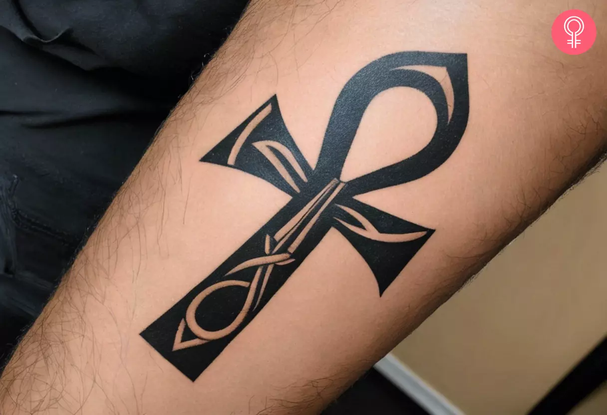 Ankh symbol tattoo on the forearm