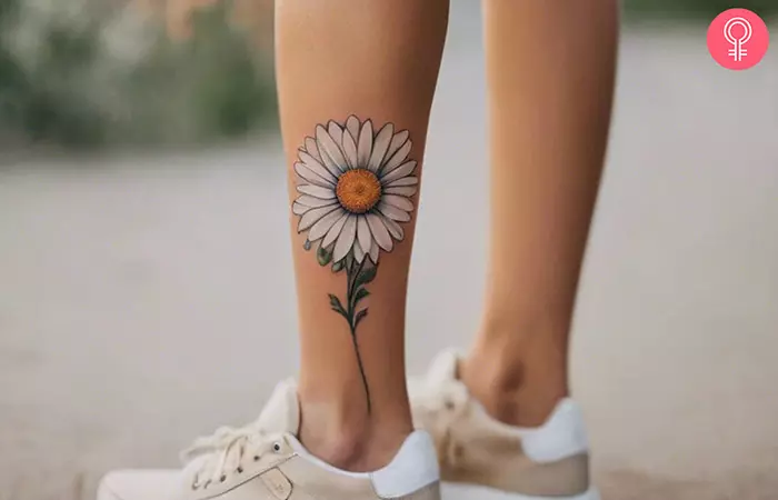 Daisy birth flower tattoo on the calf