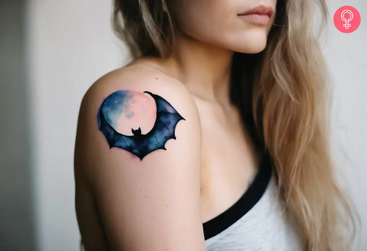 Bat and moon tattoo on a woman’s shoulder