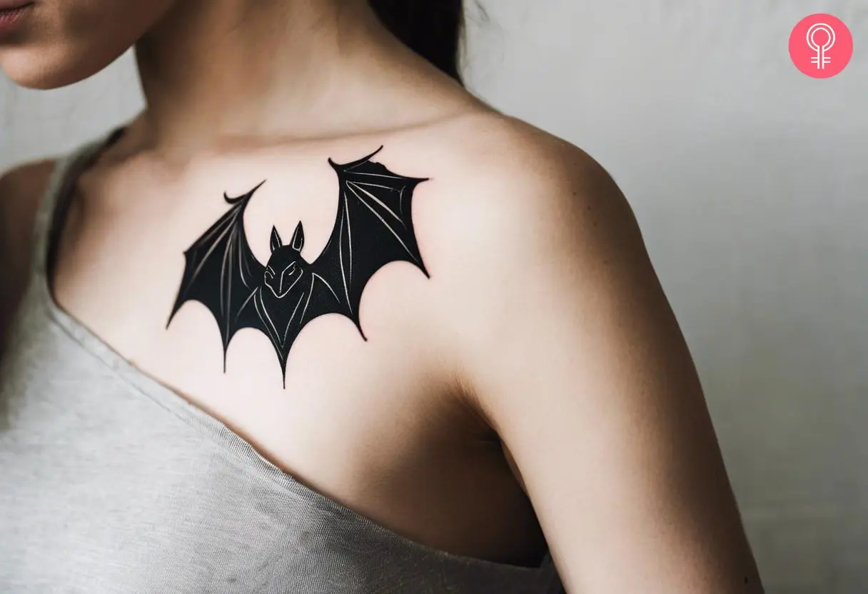 Bat tattoo in blackwork on a woman’s shoulder