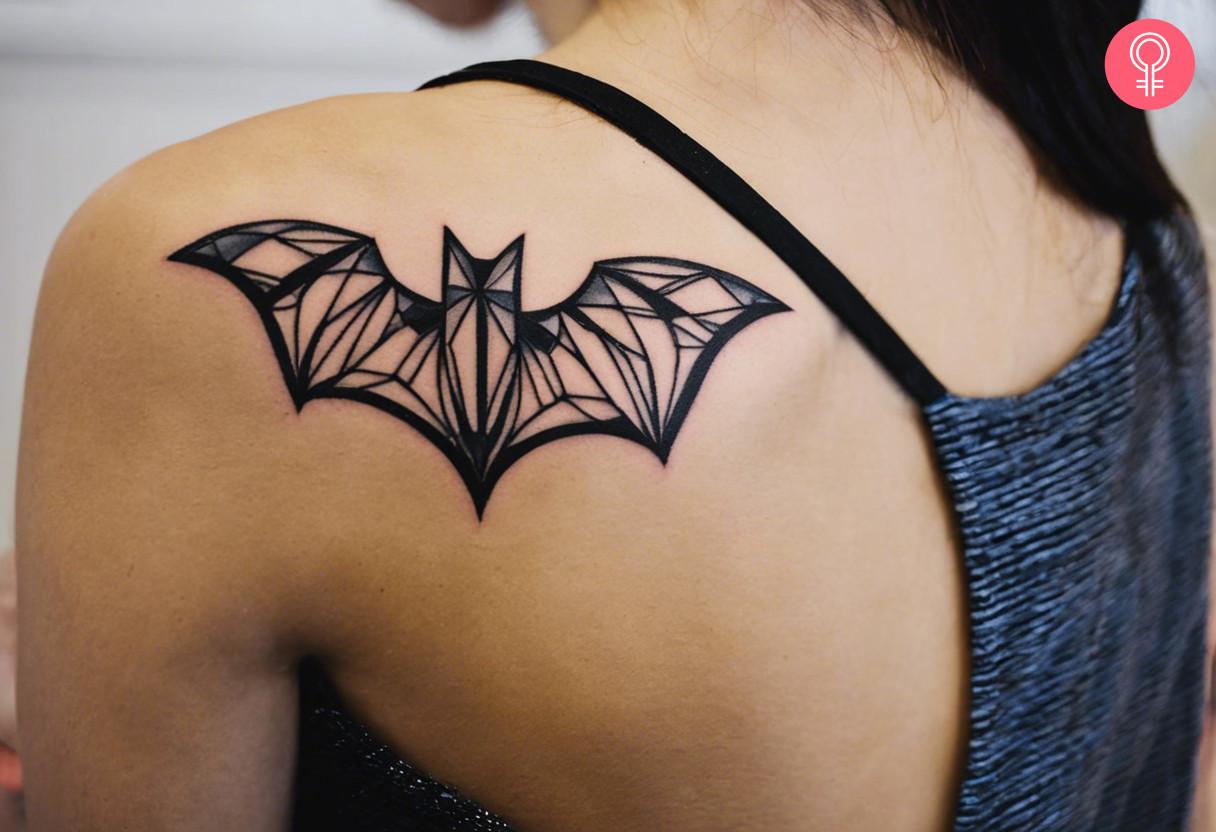 Bat tattoo on the shoulder of a woman