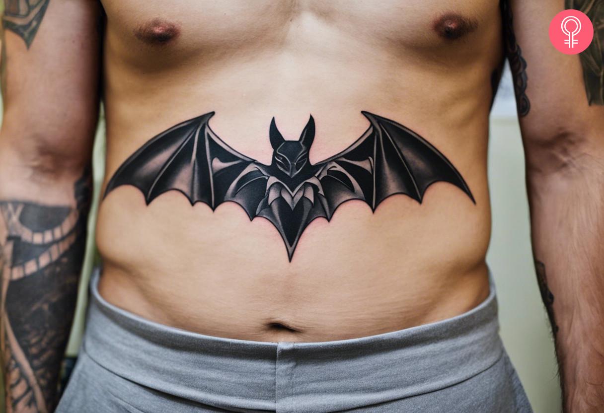 Bat tattoo on the stomach of a man