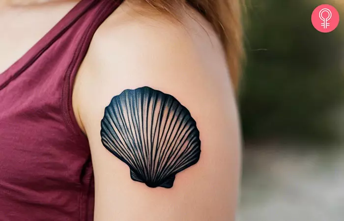 Woman with a beach-themed seashell tattoo