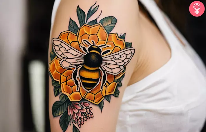 Bee honeycomb flower tattoo on the upper arm