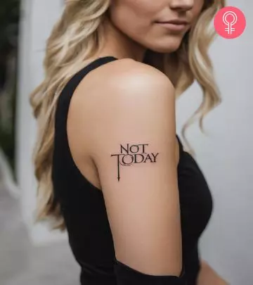 A woman with a dragon head tattoo on the shoulder