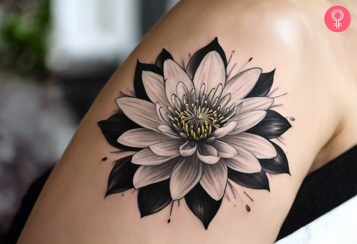 A woman wearing a black and white water lily tattoo on her arm