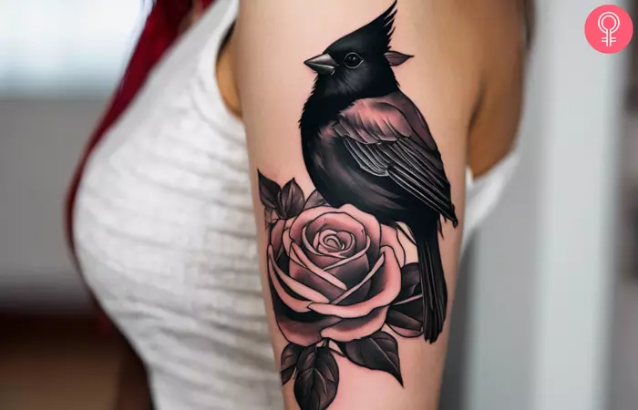 woman with black Cardinal Tattoo on her upper arm