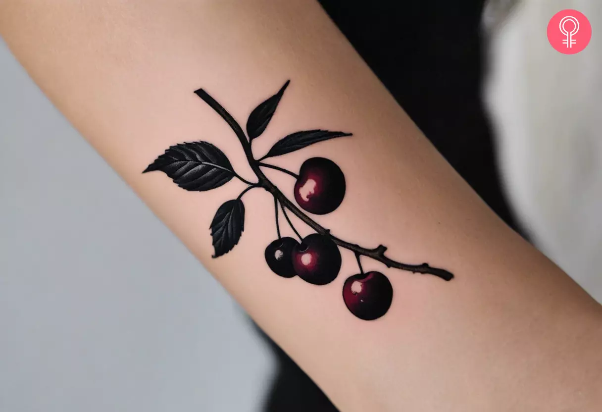 A dark cherry tattoo on the arm