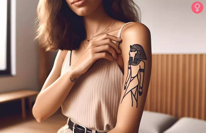 Black Egyptian tattoo on the upper arm