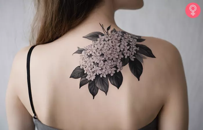 Black and white lilac tattoo on the back