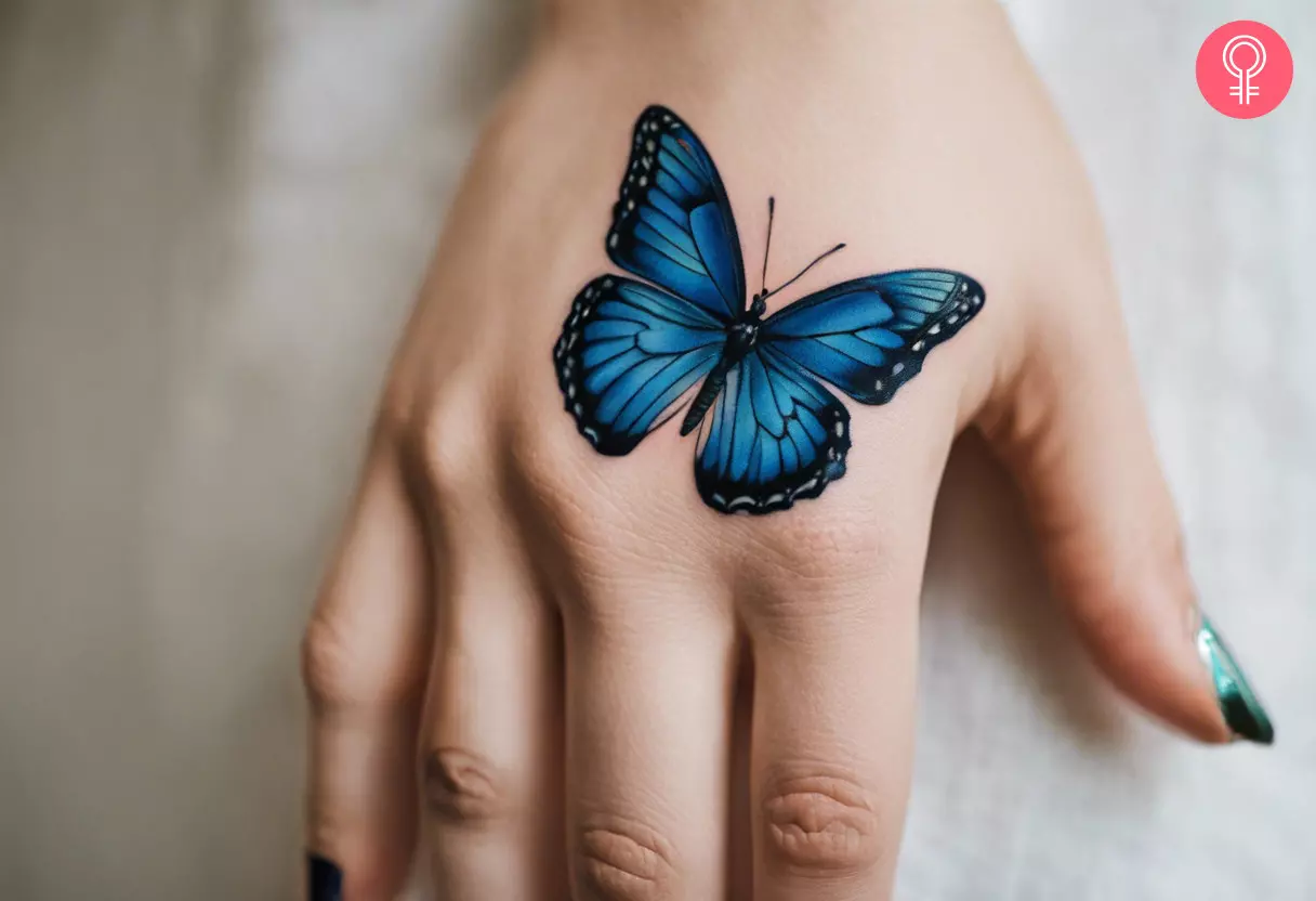 Blue butterfly tattoo on back of palm