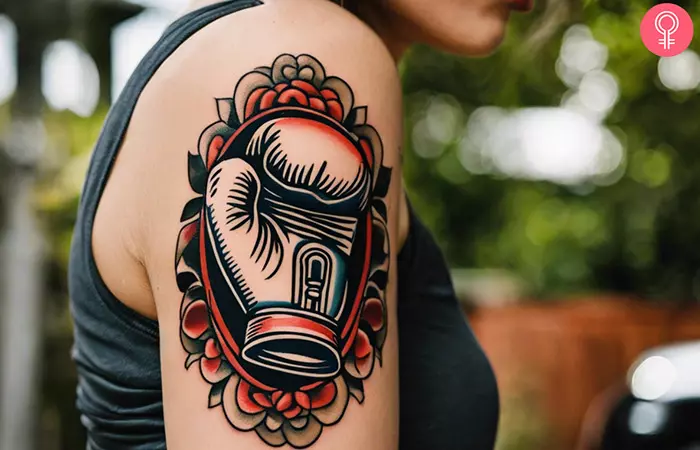 Woman with a boxing glove tattoo on her upper arm