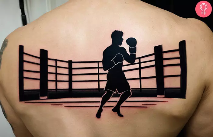 Man with a tattoo of a boxing ring on his back