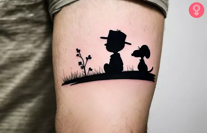 Charlie Brown and Snoopy tattoo on the upper arm