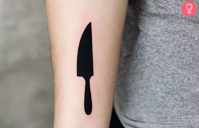 A cute chef tattoo on the forearm