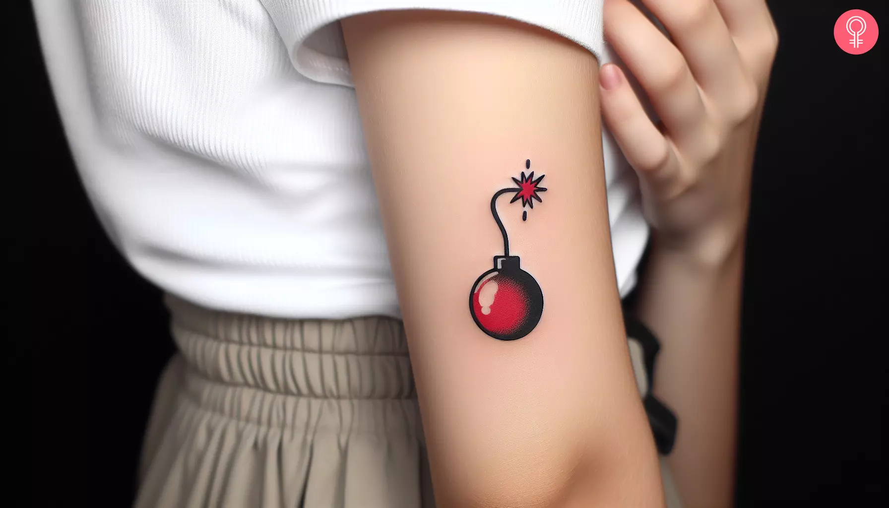 A minimalistic cherry bomb tattoo on the upper arm