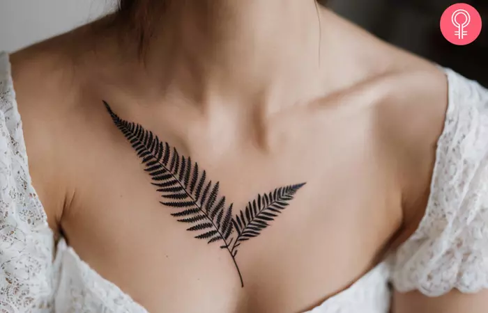 A fern leaf tattoo on the collarbone