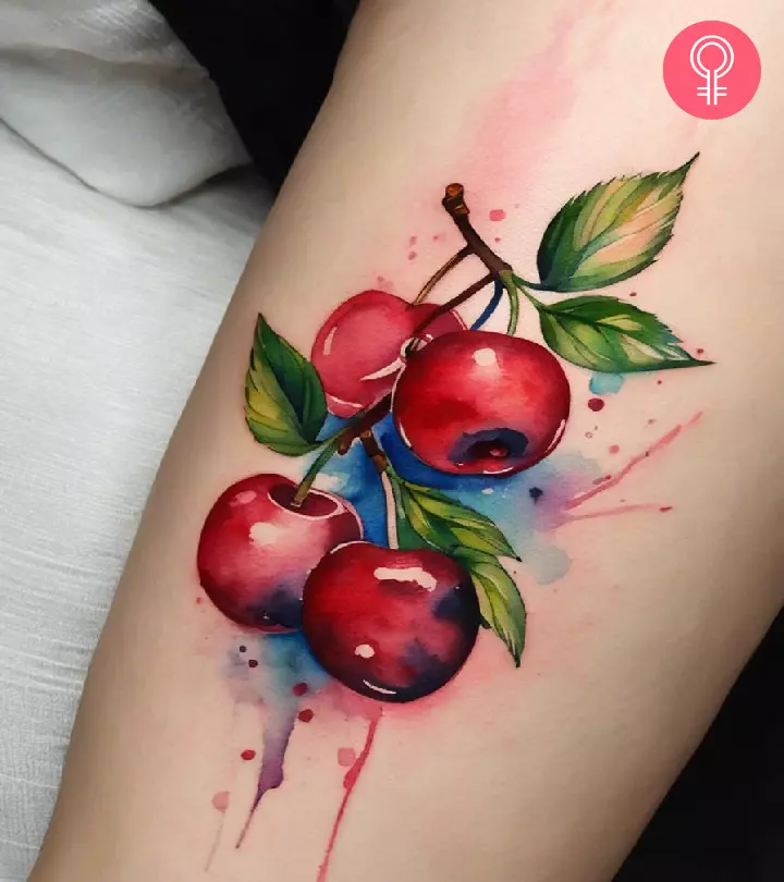 Watercolor cherry tattoo on the forearm