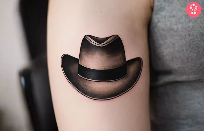 Cowboy hat tattoo on the upper arm