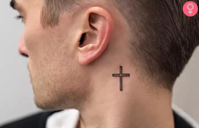 Cross tattoo behind the ear for men