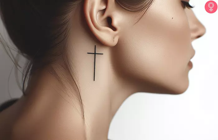 Cross tattoo behind the ear for women