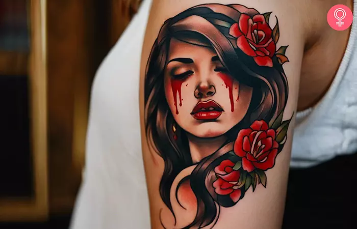 Crying blood tattoo on the upper arm