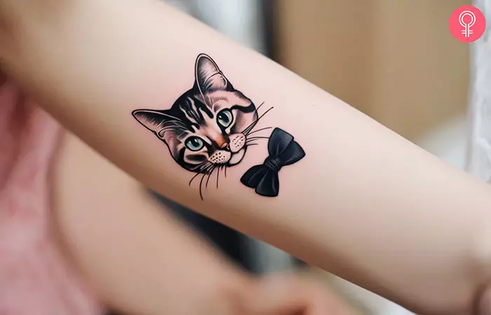 A cute cat tattoo on the forearm