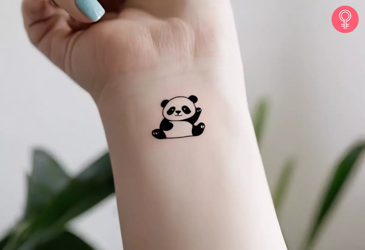 A cure panda tattoo on the wrist of a woman