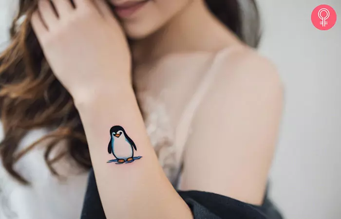 Cute penguin tattoo on the forearm