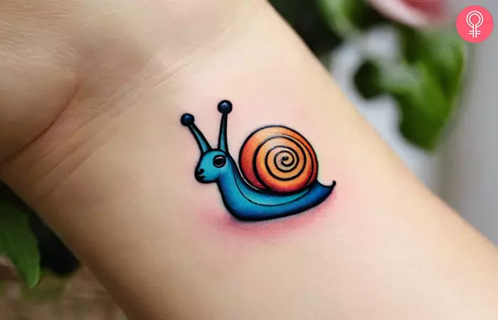 Cute snail tattoo on the wrist