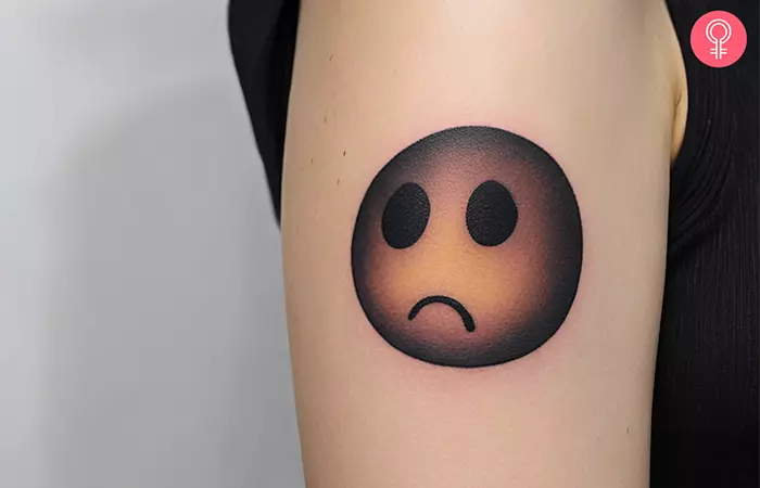 Dark sad tattoo on the upper arm