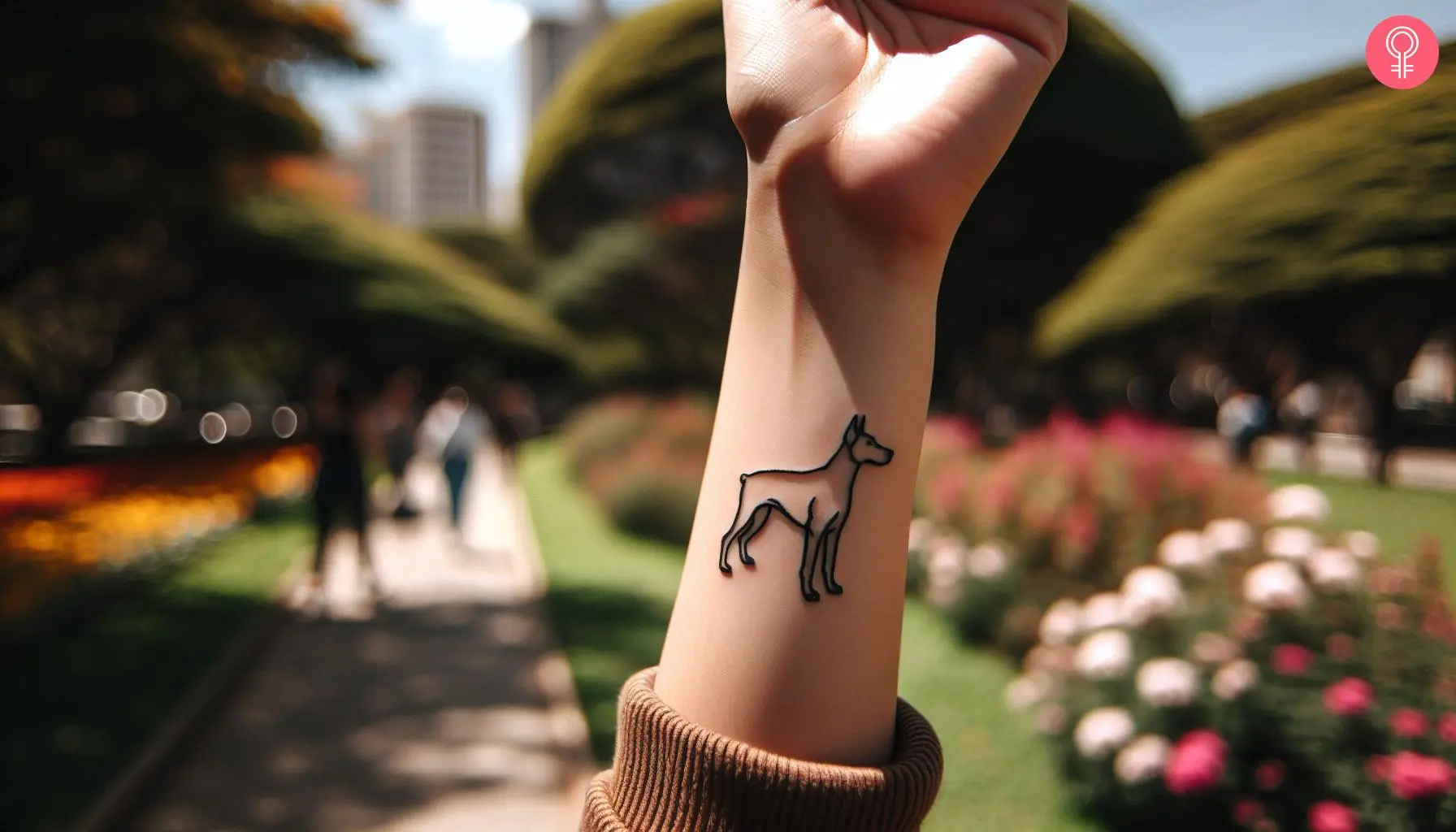 A minimalistic outline tattoo of a Doberman on a woman’s wrist