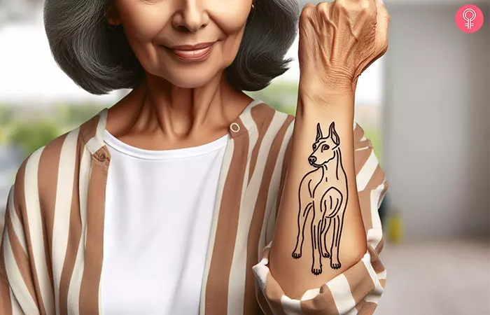 A tattoo of a Doberman’s outline on the lower arm