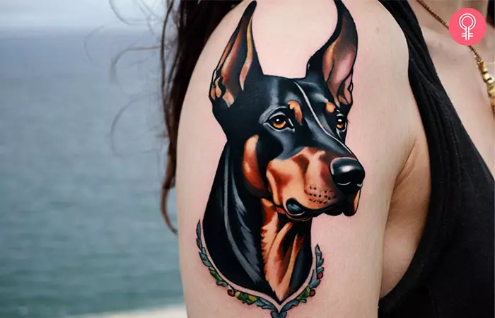 A Doberman Pinscher tattoo on the upper arm