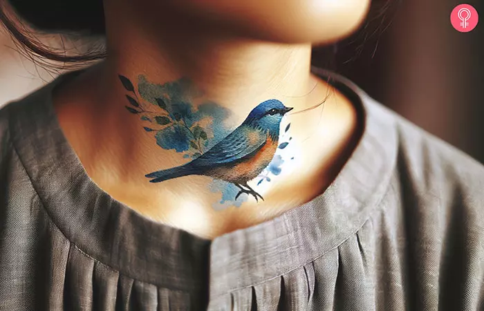 An eastern bluebird tattoo on the neck of a woman