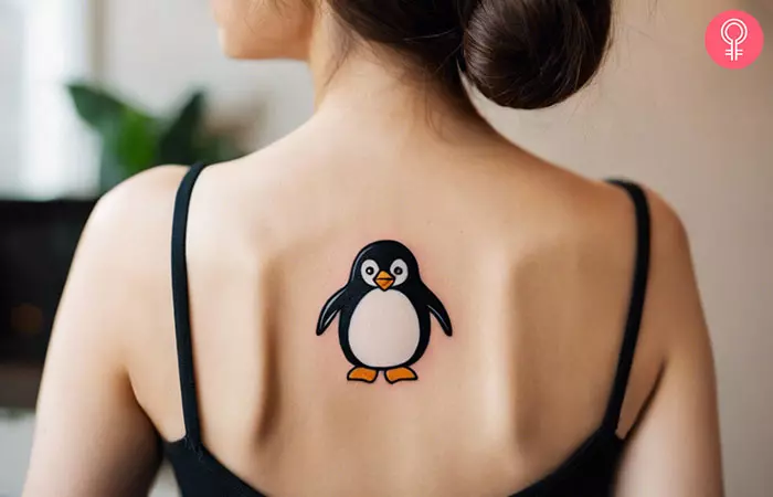 Emperor penguin tattoo on the upper back
