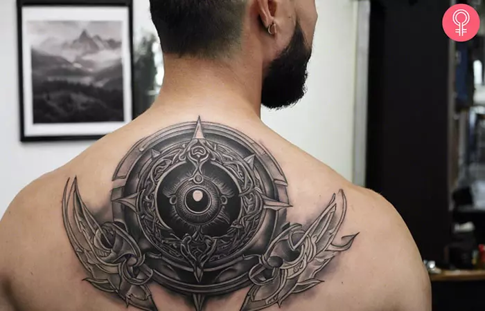 A man with an Eye Of Odin tattoo on his back