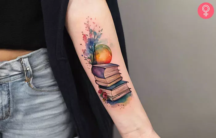 A fantasy book tattoo on the forearm