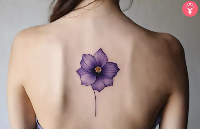 Violet birth flower tattoo on the upper back