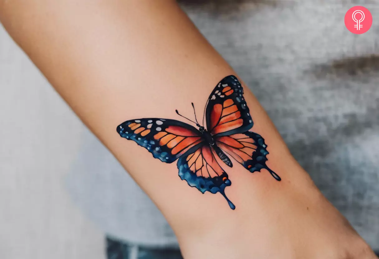 Female butterfly tattoo on forearm