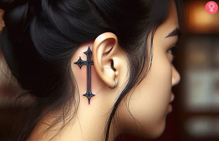 Feminine cross tattoo behind the ears