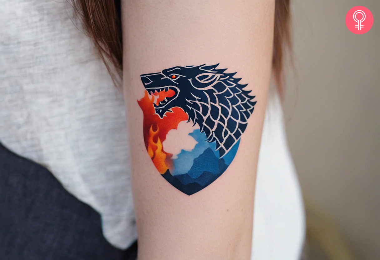 A tattoo of a wolf and a crest-shaped motif depicting fire and ice scenes