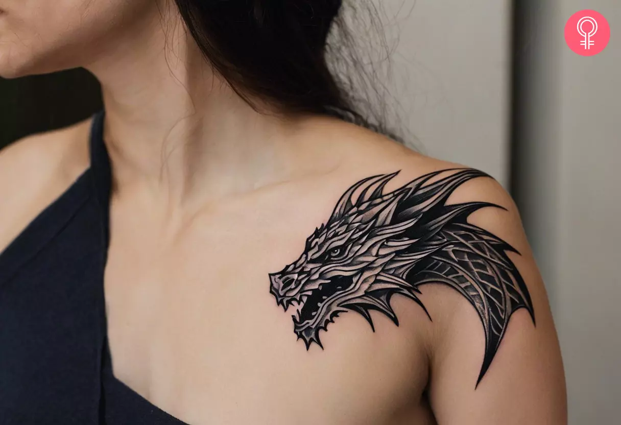 A bold dragon head tattoo on the shoulder