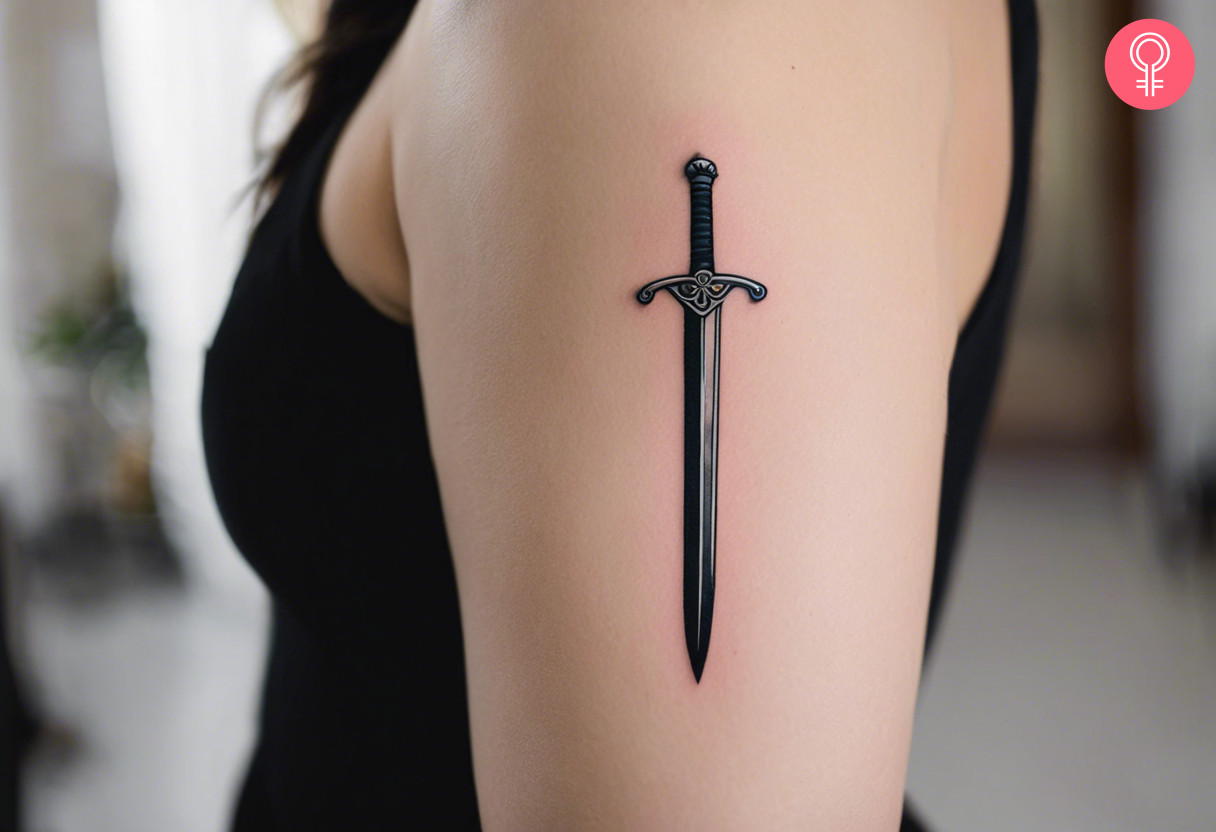 A long sword tattoo on the upper arm