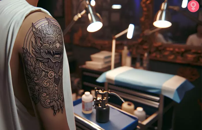 A gargoyle tattoo outline on the arm of a man