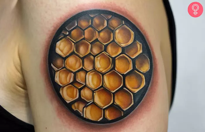Geometric honeycomb tattoo on the upper arm