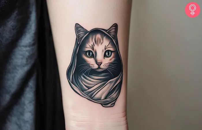 A ghost cat tattoo on the forearm